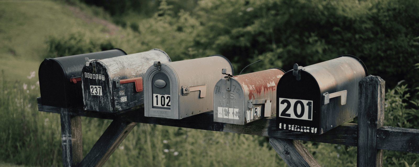 Direct mail postcards and envelopes arranged on a desk